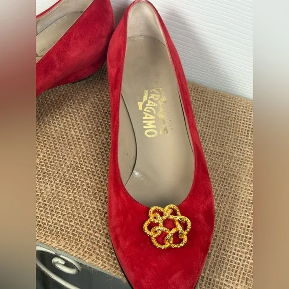 Salvatore Ferragamo red suede pumps featuring a gold-toned ornamental buckle